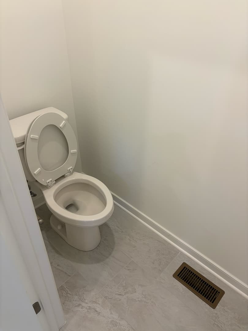 Bathroom with clean toilet and tile floor