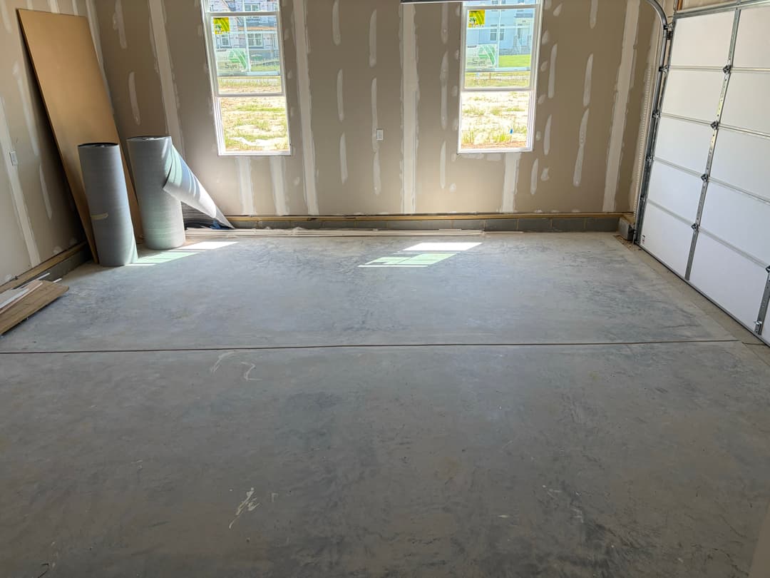 Garage after rough clean, swept concrete floor
