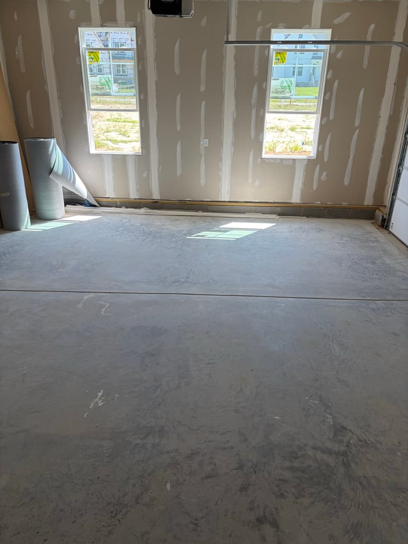 Garage floor cleared of debris and drywall dust