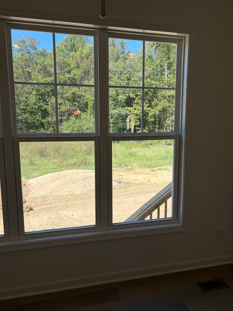 Clean double-hung window with trim and hardwood floor