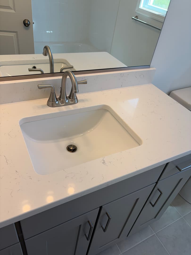 Bathroom vanity with quartz top and brushed-nickel faucet